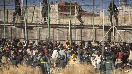 FILE - Riot police officers cordon off the area after migrants arrive on Spanish soil and crossing the fences separating the Spanish enclave of Melilla from Morocco in Melilla, Spain, on June 24, 2022. At a summit starting on Thursday, EU leaders will discuss migration. With countries like Austria, Hungary and Poland blocking any meaningful attempt to equitably share out refugees arriving in Greece, Italy, Malta or Spain, the work is focused on preventing migrants from coming in. (AP Photo/Javier Bernardo, File)